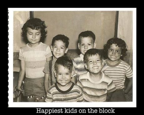 Six children in striped shirts, photographed in the 1950s, captioned Happiest kids on the block.